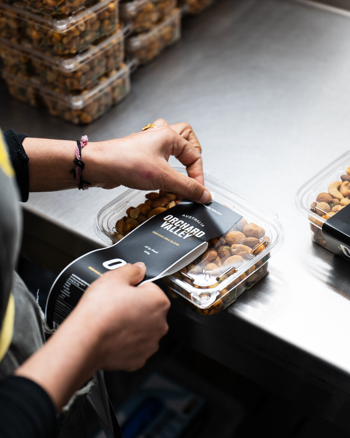 A tub being labelled by hand.