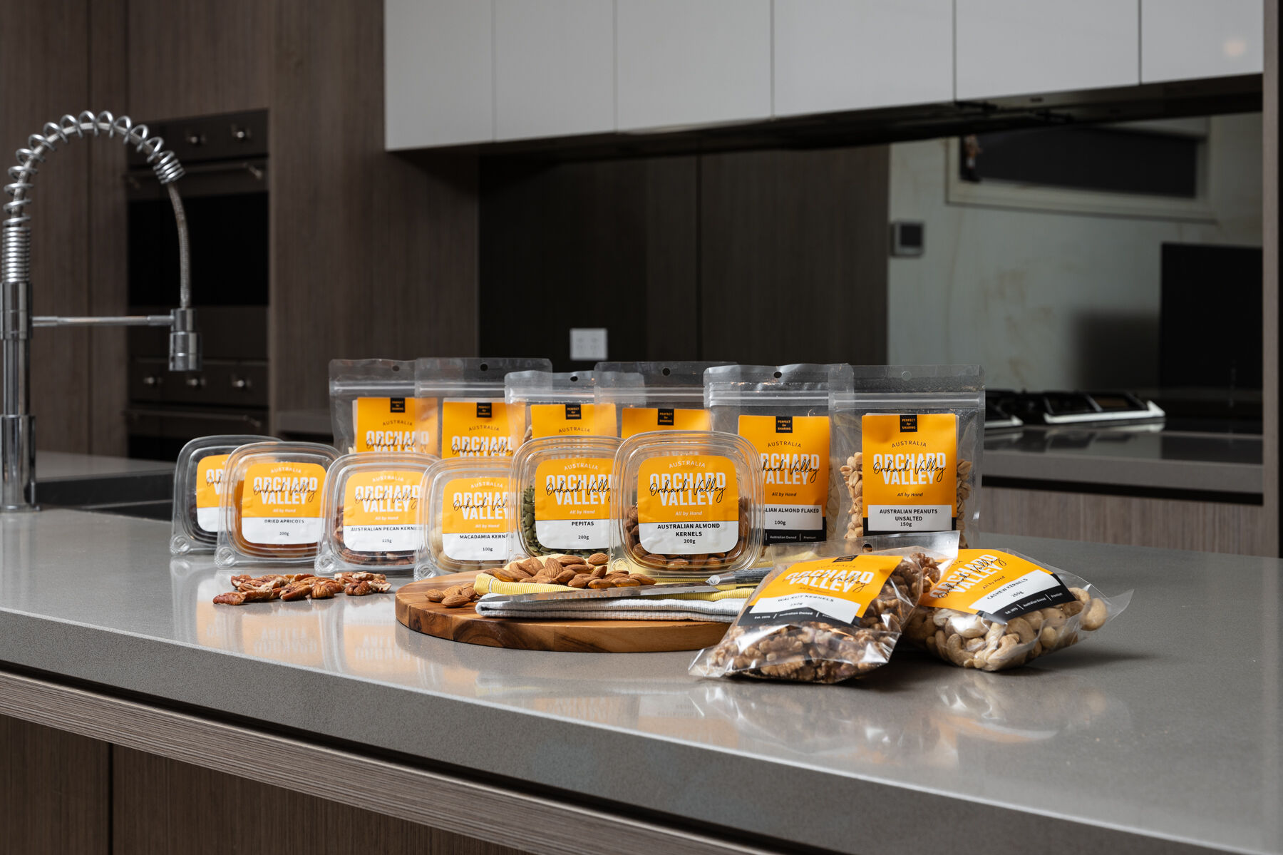 Orchard Valley packets and tubs on a kitchen bench.