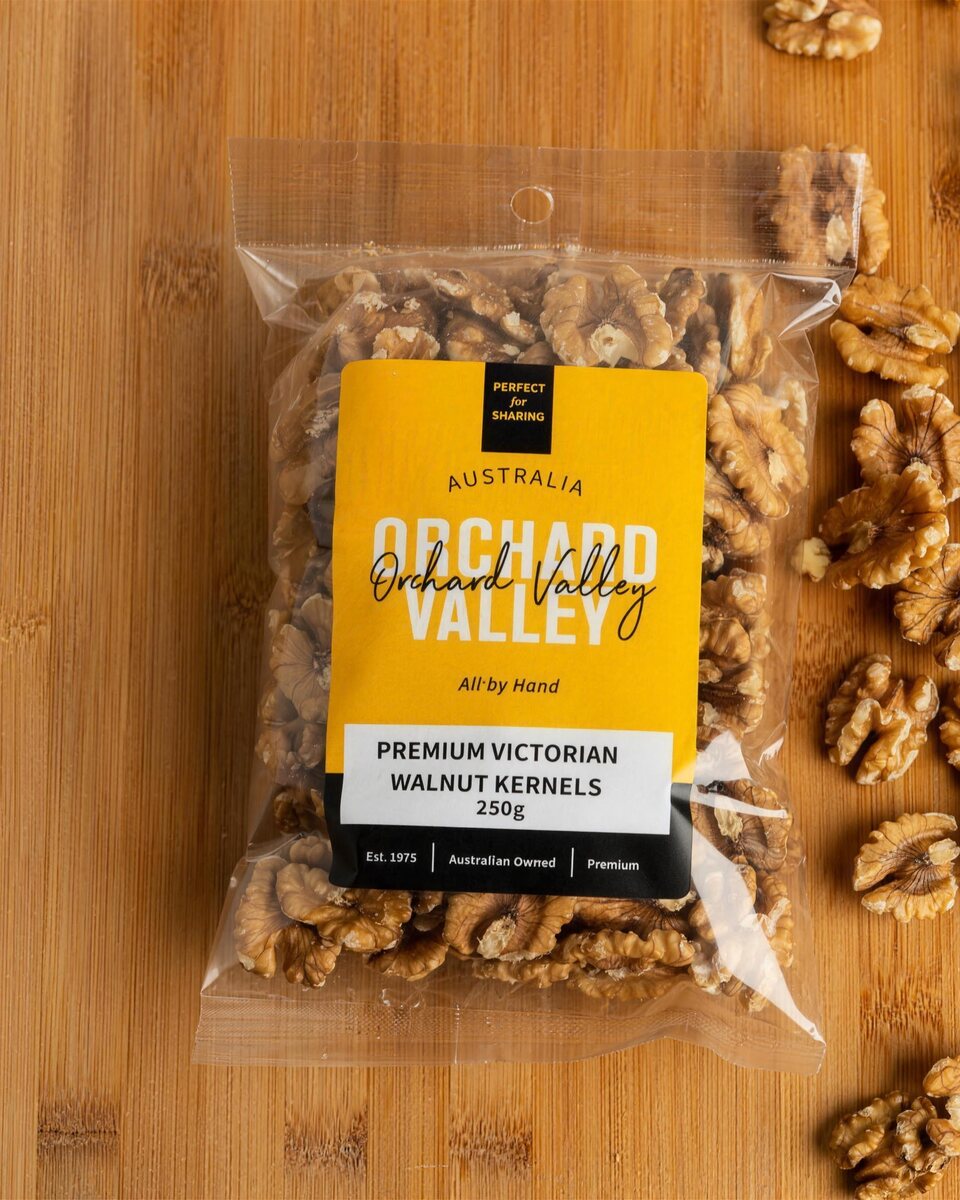 Orchard Valley Premium Victorian Walnut Kernels 250g on a timber board with walnut halves.