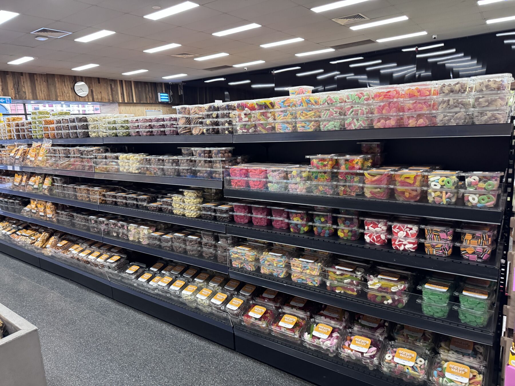 A wall of chocolate and lolly tubs.